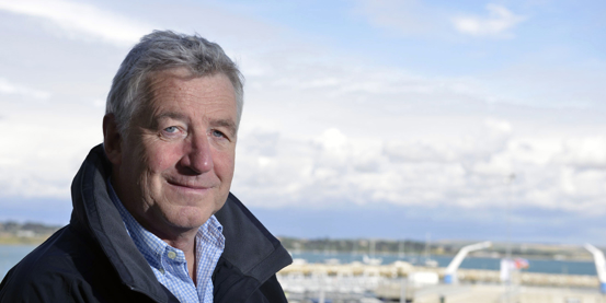 Profile photo of Pete Allam posing in front of the water
